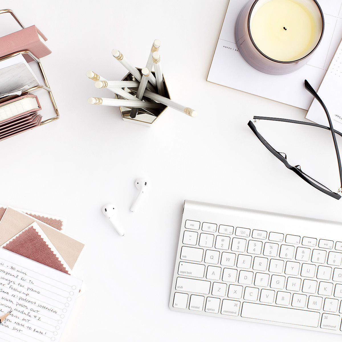 Workspace image with keyboard, glasses and candle